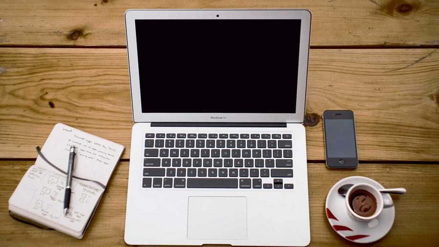 Notebook and laptop on an office desk